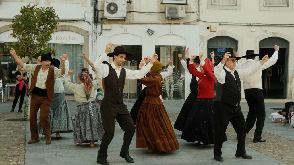 A group of people dancing in front of a building